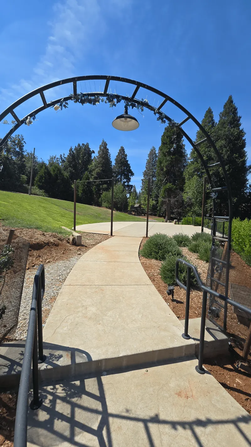 Walkway under decorative iron arch leading to the winery grounds